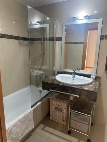 a bathroom with a sink and a shower and a tub at Somni Cambrils in Cambrils