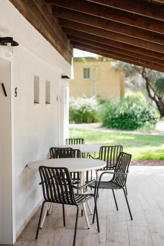 a group of chairs around a table on a patio at כפר הנופש קיבוץ גדות Kibbutz Gadot Galilean Resort in Gadot