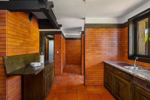 a bathroom with a sink and wooden walls at Isatour - Ninho D' Águia in Águeda