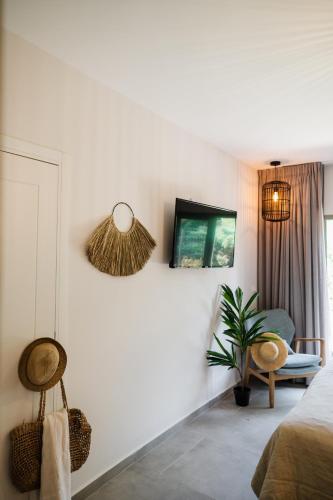 a bedroom with a bed and a tv on a wall at כפר הנופש קיבוץ גדות Kibbutz Gadot Galilean Resort in Gadot