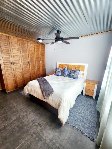 a bedroom with a large bed with a metal ceiling at Casa Cara Resort in Parys