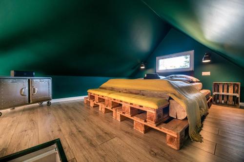 um quarto com uma cama feita de troncos em Domandi mountain holiday lodges em Przesieka