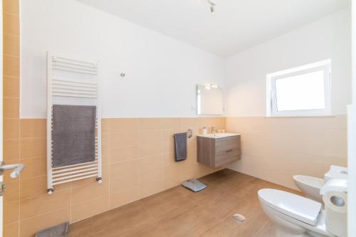 a bathroom with a toilet and a sink and a mirror at Casa do Sobreiro in Cantanhede