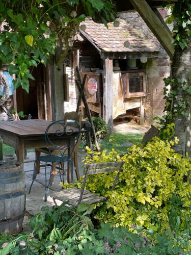 a table and chairs in front of a house at La Ferme de Marie in Rangen