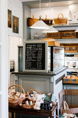 a kitchen with a microwave on a counter with baskets at La Maison d’Hôtes in Silly