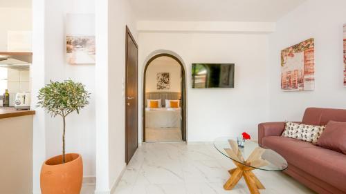 a living room with a couch and a table at Pamina Mare in Nea Skioni