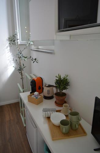 a kitchen with a counter with cups and dishes on it at Il frantoio di Olimpia in Lerici