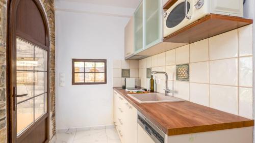 a kitchen with a sink and a counter at Pamina Mare in Nea Skioni