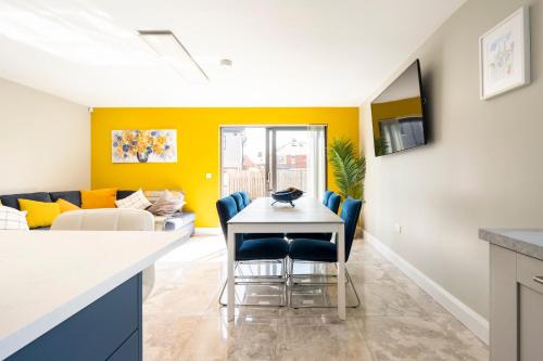 a kitchen and living room with a table and chairs at Park House - FOUR star luxury with parking and WI-FI in Belfast