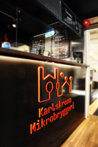 a restaurant with a sign on the side of a counter at The Brewery Hotel in Karlskrona