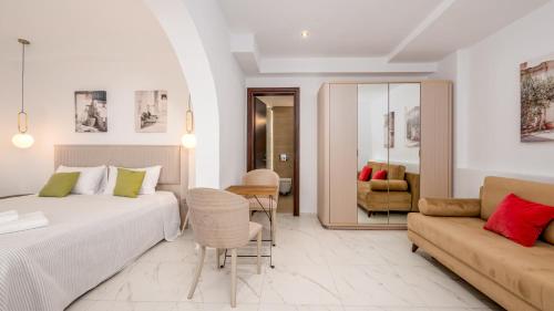 a hotel room with a bed and a couch at Pamina Mare in Nea Skioni
