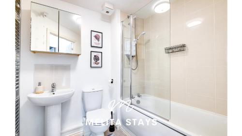 a bathroom with a shower toilet and a sink at Spacious 2 bedroom apartment with gated parking in Solihull