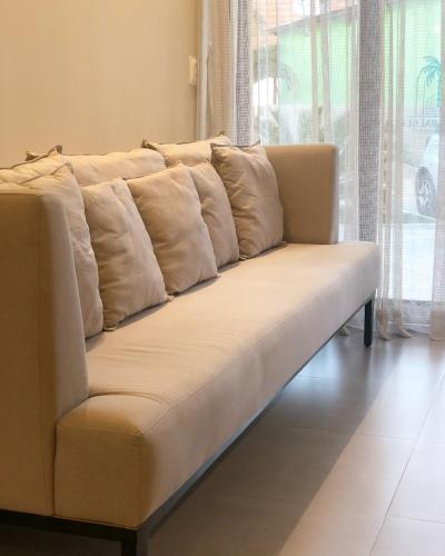 a white couch with pillows on it in a living room at Hotel Icaraí Beach in Icaraí