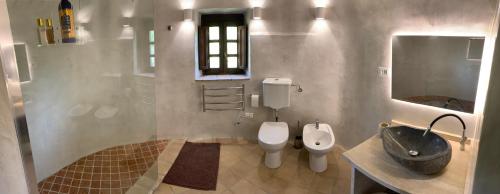 a bathroom with a sink and a toilet and a mirror at Castello del Poderetto in Licciana Nardi