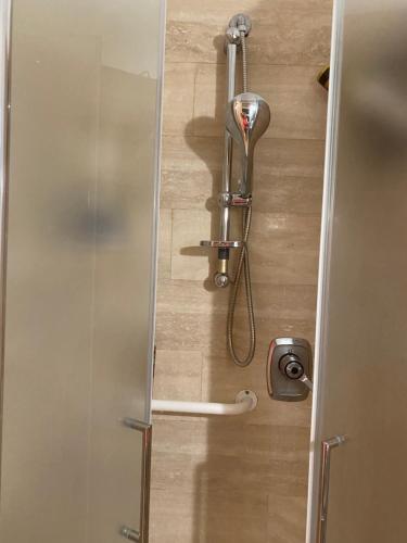 a shower in a bathroom with a glass door at Sunny house in SantʼAmbrogio di Valpolicella