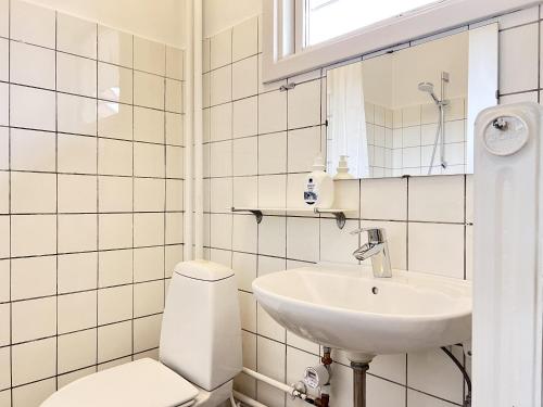 a white bathroom with a toilet and a sink at Studio Apartment In Herlev, Herlevgrdsvej 2, 4 in Herlev