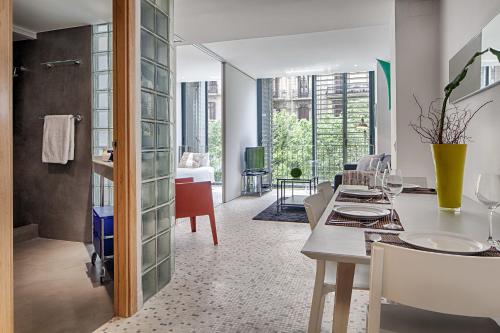 a kitchen and dining room with a table and chairs at Habitat Apartments Pedrera in Barcelona