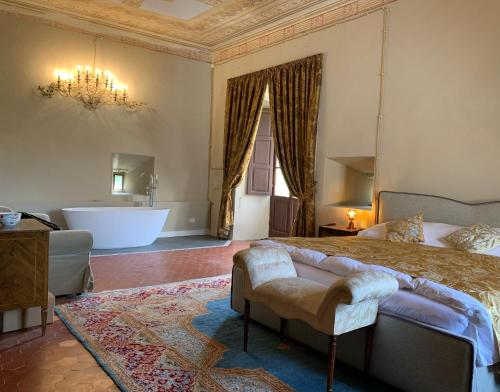 a bedroom with a bed and a tub in a room at Castello del Poderetto in Licciana Nardi