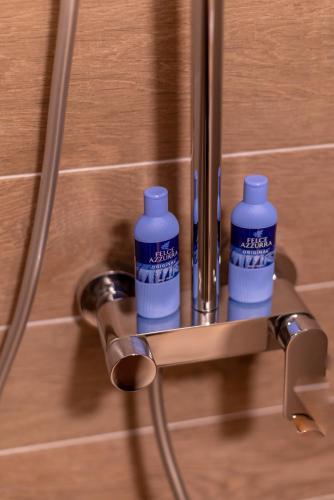 two bottles of water sitting on a door handle at Studio 106 Apartment in Palić