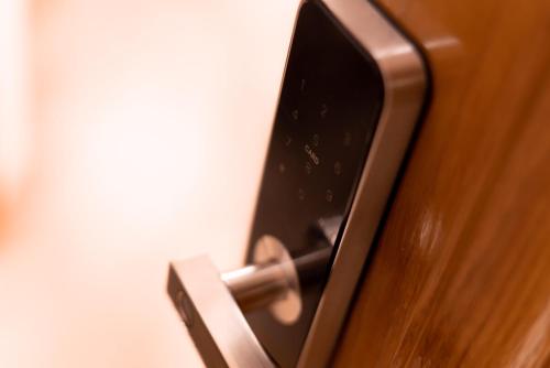 a close up of a door handle on a wooden door at Studio 106 Apartment in Palić