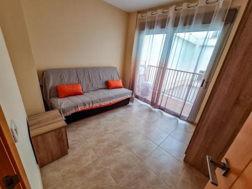 a living room with a couch and a large window at Las Jarcias in Moncófar