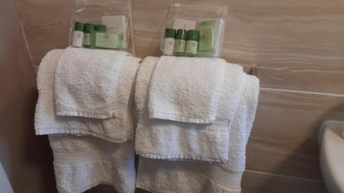 a bathroom with white towels on a towel rack at Otters Retreat in Big Sand