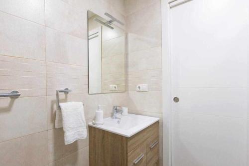 een witte badkamer met een wastafel en een spiegel bij Luna de Málaga in Málaga