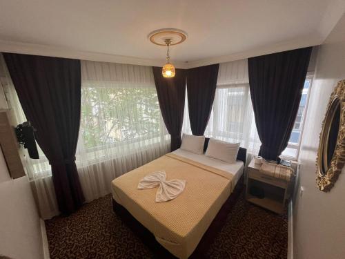a small bedroom with a bed and a window at Metropol hotel 2 in Istanbul