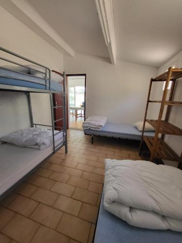 a room with two bunk beds and a ladder at Camping de Puyloubier in Puyloubier