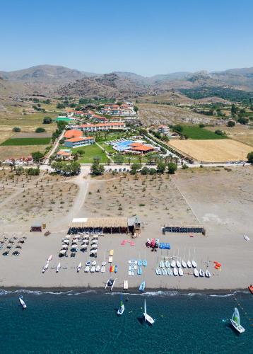 an aerial view of a beach with boats in the water at Aeolian Village Beach Resort in Skala Eresou