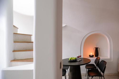 a dining room with a table and chairs at Aethria Villa in Imerovigli