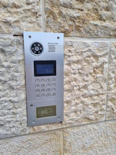 a machine on the side of a stone wall at Cute Studio near Yad Vashem FREE street parking in Jerusalem