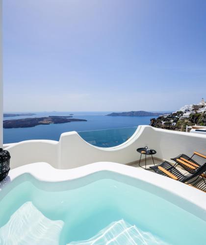 a swimming pool with a view of the ocean at Aethria Villa in Imerovigli