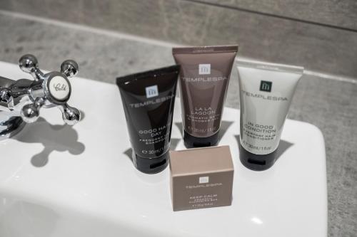 a group of three products sitting on a bathroom sink at Knipoch House Hotel in Oban