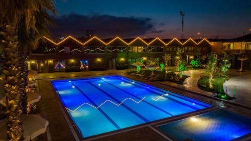 a swimming pool lit up at night at Sandal Otel in Trabzon