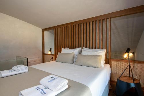 a bedroom with a large white bed with towels on it at Balos Beach in Kissamos