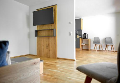 a living room with a flat screen tv on a wall at Zapfig Living Arlberg in Wald am Arlberg