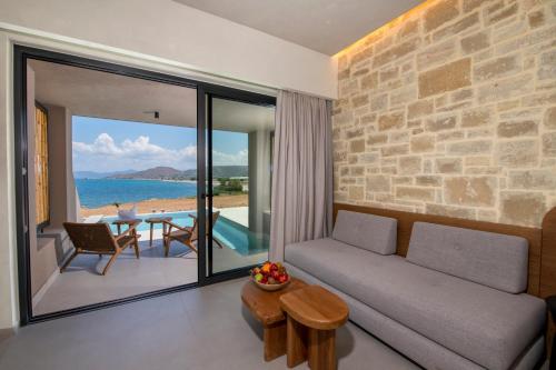 a living room with a couch and a view of the ocean at Balos Beach in Kissamos