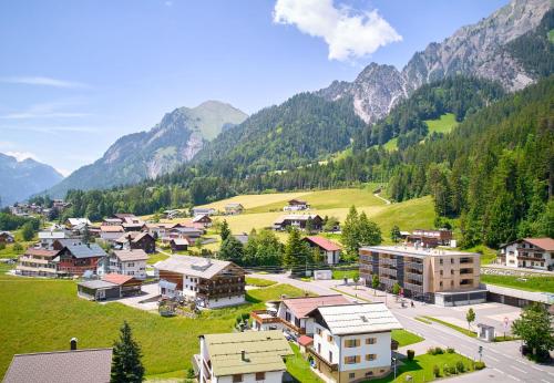 a small town in a valley with mountains in the background at Zapfig Living Arlberg in Wald am Arlberg
