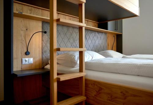 a bunk bed with a ladder to a bunk bed with a bunk bed at Zapfig Living Arlberg in Wald am Arlberg