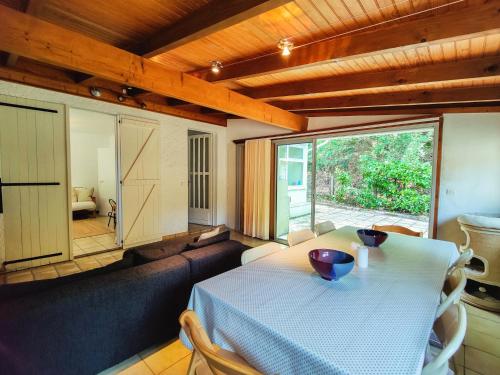 un salon avec une table et un canapé dans l'établissement Maison chaleureuse et spacieuse, à Lacanau