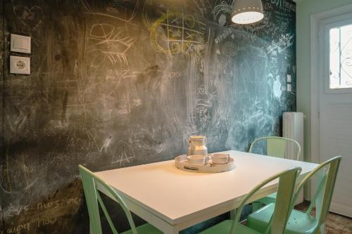 a table and chairs in a room with graffiti on the wall at Victoria metro st. 1 bedroom 4 persons by MPS in Athens