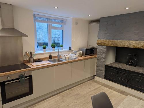 a kitchen with a sink and a counter top at Fernworthy in Okehampton