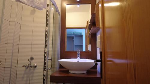 a bathroom with a white sink and a shower at Gumbet Cove Hotel in Gümbet