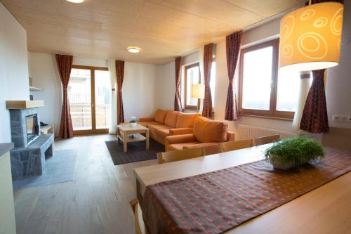 a living room with a couch and a table at Lake Peak Apartments, Ribniško Pohorje in Ribnica na Pohorju