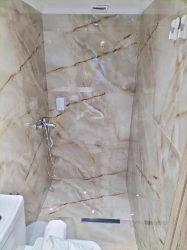 a marble shower in a bathroom with a toilet at M&S Corfu Centre Apartment in Ágios Rókkos