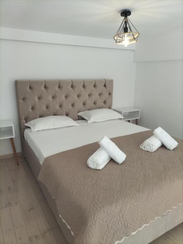 a bedroom with a large bed with two pillows at M&S Corfu Centre Apartment in Ágios Rókkos