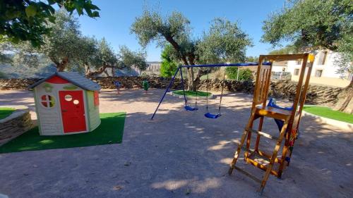 a playground with a swing set and a ladder at Casalagata in Alcántara
