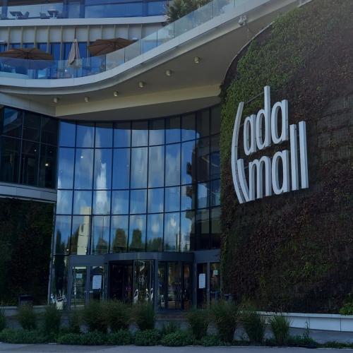 a building with a sign on the side of it at RIVIJERA LAKES Ada Studio in Belgrade