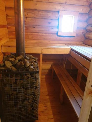 a wooden table and bench in a wooden cabin at Karostas pirts namiņš in Liepāja